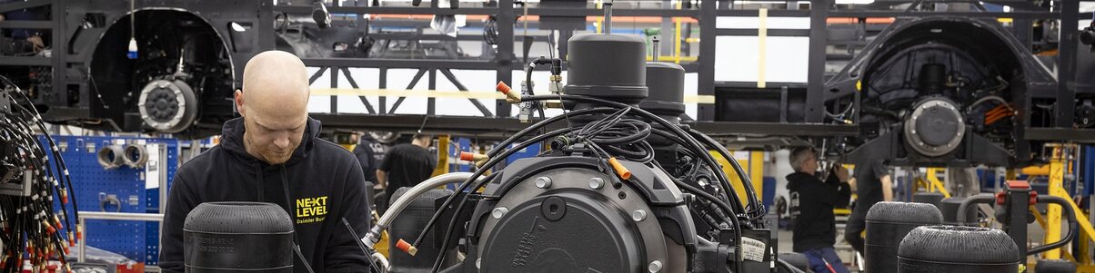 An employee assembles vehicle components in vehicle production at Daimler Buses.