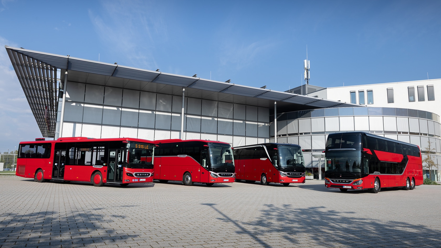 [Translate to Deutschland-en:] Setra vehicles from the intercity and coach segment are standing in front of an office building.
